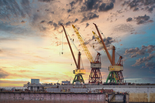 Massive blue, orange and yellow cranes in harbour