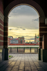 Russia, Yoshkar-Ola, July 24, 2020, view through the arch on the embankment of the Kokshaga river, the bridge and the Kremlin.