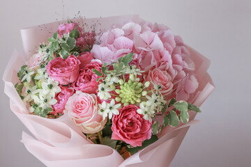 Pink flowers bouquet of roses, hydrangea, green eucalyptus leaves on a light background
