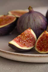 Fresh figs on a plate on a light concrete background