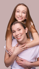 Elder mother and teenager daughter hug. Happy family portrait. Similar smile. Next generation love. Single mom. Mature parent. Smiling people group. Attractive posing together. Two hand connection