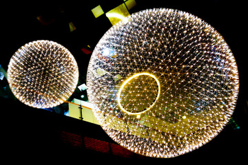 Big circle globe light like earth planet star in space or universe hang on the ceiling. in dark or black background.