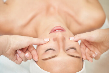 Beautiful portrait on white background. Cosmetology massage. Young woman facial medical treatment. Skin care concept. Nature people. Beauty spa salon. Face mask procedure. Healthcare rejuvenation