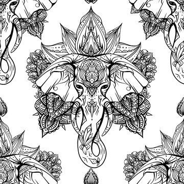 Seamless pattern with ethnic elephant head with mehendi decoration and mandala on white background. Spiritual Ganesha with tribal decoration. Vector texture for fabrics, wallpapers and your creativity