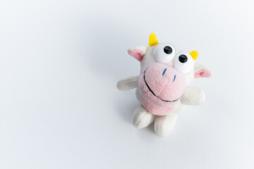 Children's soft toy bull, on a white background. A cute toy for children's games. Symbol of the new year 2021.Copy space