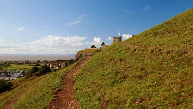 Slow POV walk towards the stunning Old Church of St Nicholas at Uphill, Somerset, England, UK dating from around 1080
