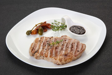 Grilled pork steak with pepper sauce
