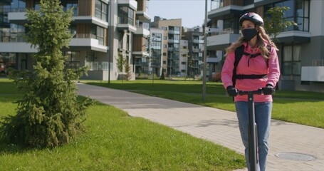 Naklejka premium Fast food delivery courier rides electric scooter