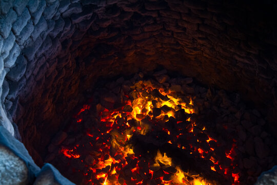 Traditional limestone kiln in Sri Lanka. Lime pit firing