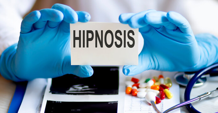 text HIPNOSIS write on a medicine card. Medical concept with a stethoscope and pills