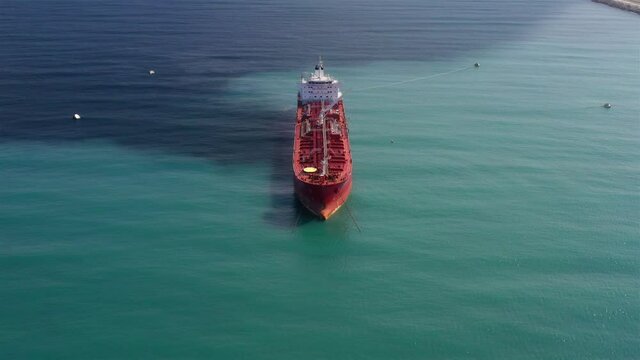 Oil spills out of a ship to Sea- Aerial View
Drone view of oil Chemical Tanker Tied with strings Spills oil in the sea
