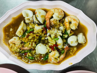 Stir fried shrimp and squid with chili in Thailand.