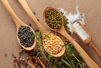 Various raw lentils with rosemary, salt and pepper.
