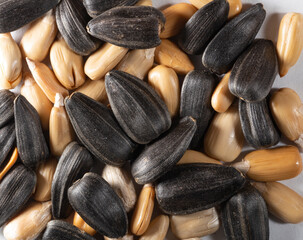 Sunflower seeds on a white background, unpeeled and peeled. Without a shell. Macro.