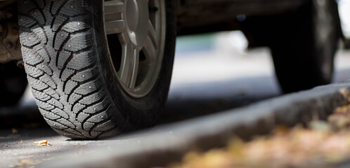 Wheel with winter studded tires. Close up