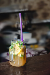 Uzvar from different herbs with citrus lemons and lime on the bar in a glass glass. Copy space