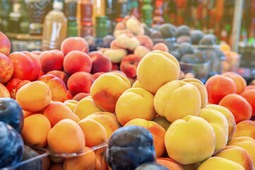 harvest of ripe peaches is on the counter of the farmers ' market. harvest is for sale