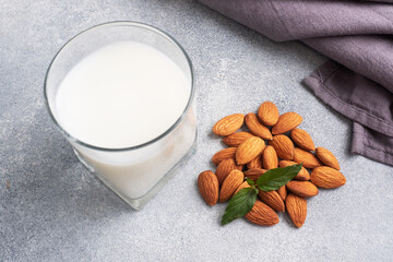 Almond milk in glass glasses on a gray background. Copy space.
