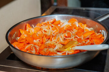Stewed vegetables. In a large frying pan, fry carrots with onions and vegetables. Cooking in a restaurant