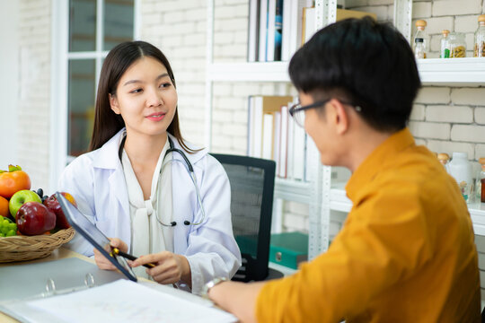 Young Asian man come to meet the nutritionist in hospital and talking about dieting and eating.