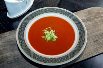 Gazpacho diet tomato soup with herbs and cucumber on a plate