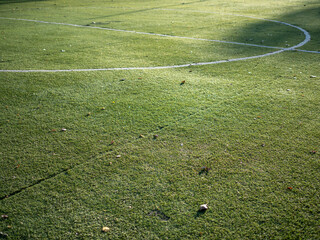 White lines of kick-off circle on a football field with synthetic turf. White layout of the center...