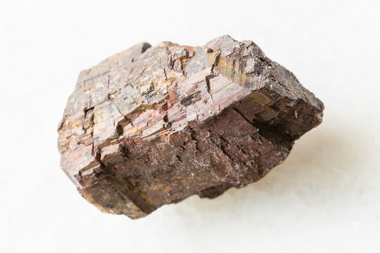 closeup of sample of natural mineral from geological collection - unpolished Siderite rock on white marble background from Cordoba, Andalusia, Spain