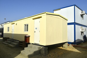 Fototapeta na wymiar Portacabin, porta cabin, temporary labors camp , Mobile building in industrial site or office container Portable house and office cabins. Labor Camp. Porta cabin. small temporary houses