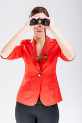 Portrait of Caucasian Brunette Girl Posing With Binoculars Against White Background.