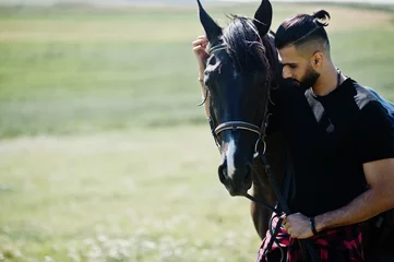 Tuinposter Arab tall beard man wear in black with arabian horse. © AS Photo Family