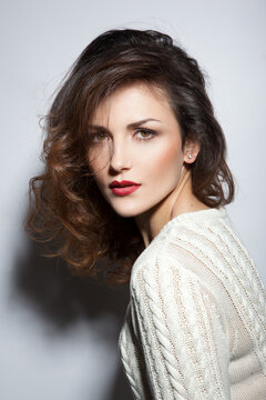 Portrait of elegant woman with red lips and hairstyle.