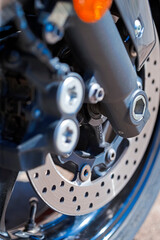 Closeup of Modern Motorcycle Front Braking System With Pads and Disks.