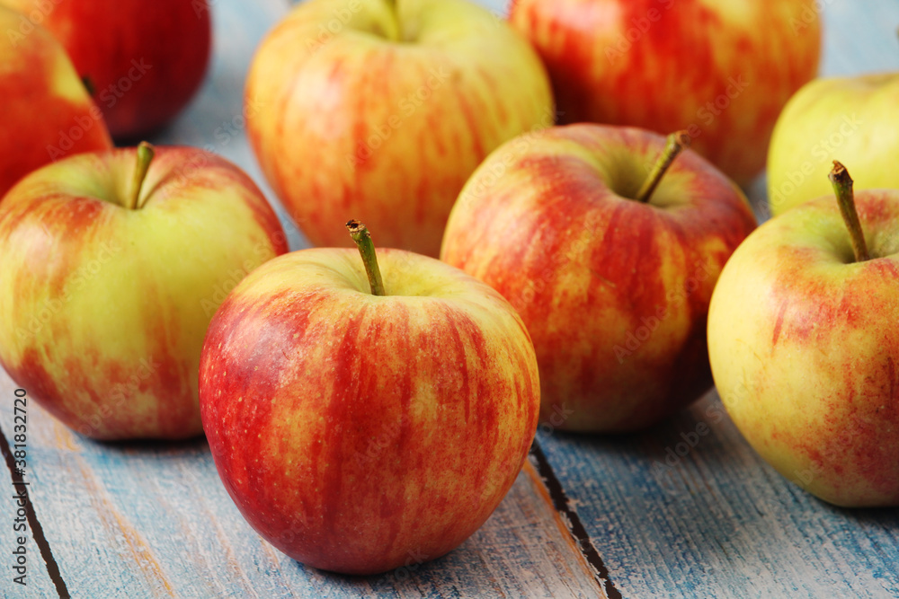 Poster several ripe red apples on the wooden table