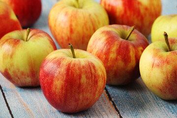 Several ripe red apples on the wooden table