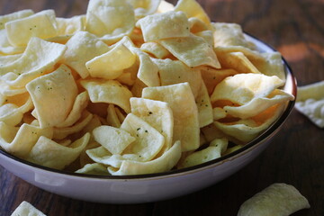 Healthy snack of low-fat lentil chips with herbs and sour cream in bowl
