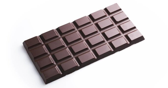 Whole bar of chocolate isolated on white background, rotates 360 degrees clockwise.