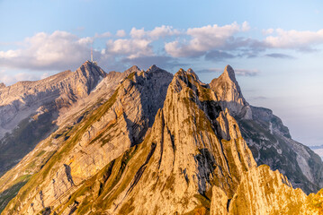 Obraz premium View of the colorful sunrise on the top the Santis mountain with its weather station as seen from the Schaefler peak in the Alpstein range Appenzell, Switzerland