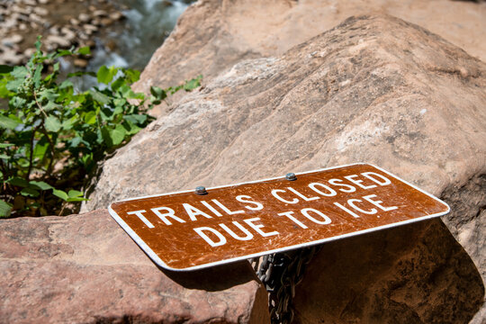 Trail closed to to ice sign fallen down on the rock