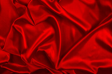 Obraz premium Red silk or satin luxury fabric texture can use as abstract background. Top view.