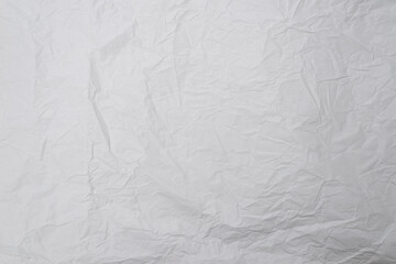 Crumpled white paper background.