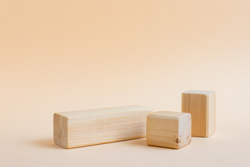 Rectangular wooden shapes on a neutral background with place for text. Empty podium or stand for displaying products, eco cosmetics. Showcase or podium of geometric shapes