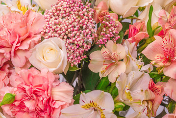 Bouquet of  soft pink flowers in wrapping paper.