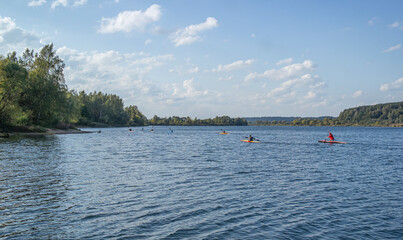 Fototapeta na wymiar Water sports image, people rowing in canoe on river