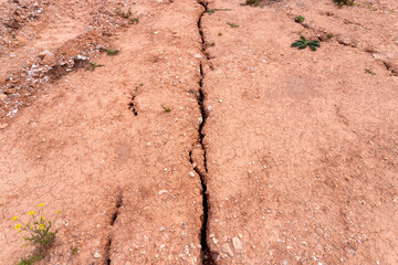 Dry, cracked ground into the dry season. Global warming and climate change.