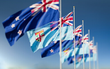 Waving flags of New Zealand and the Fiji Island. A symbol of political and economic relations between two countries. Partnership and competition in the world stage.