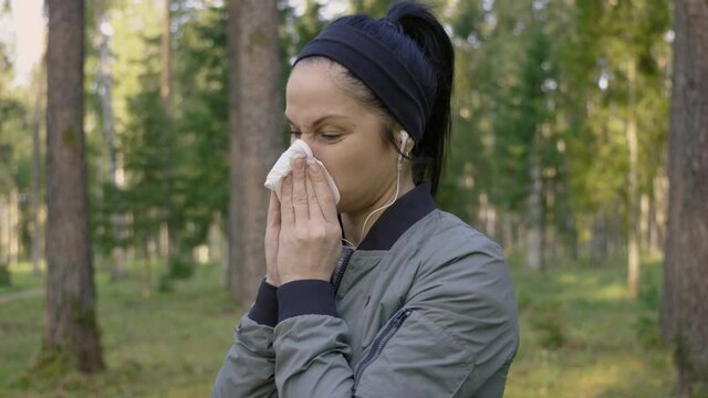 Woman with running nose at outdoors