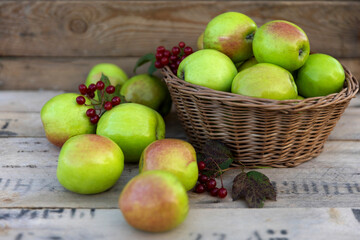 Healthy organic apples in a basket on a wooden background. The concept of a healthy diet.