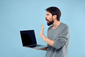 Bearded man laptop in hand internet wireless technology emotions blue background