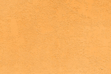 Saturated orange pastel colored low contrast Concrete textured background with roughness and irregularities. 2021, 2022 color trend.