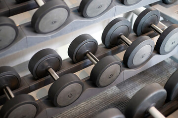 Fototapeta na wymiar Dumbbell rack in the fitness room